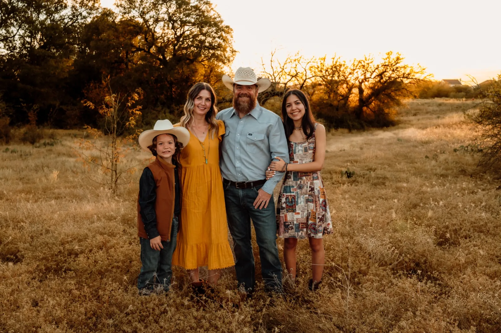 Marcus Tilton with his family outdoors at sunset